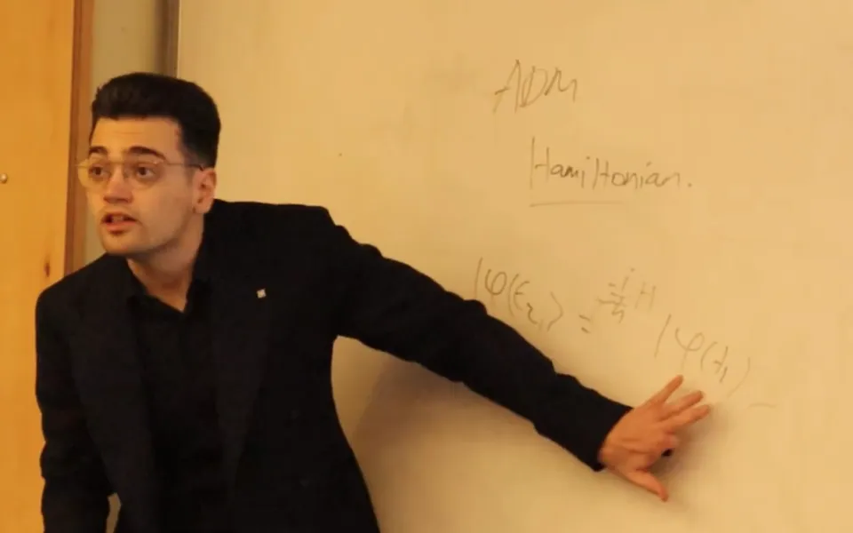 Eren Erberk Erkul presenting at the whiteboard during the METU talk
