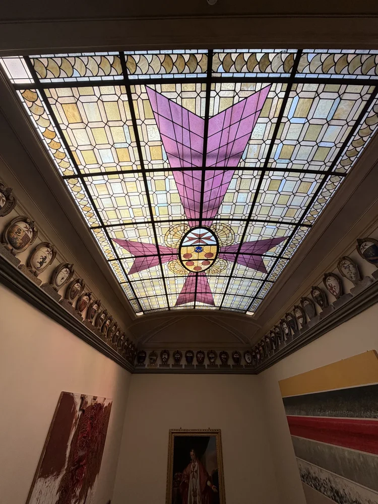 A coloured glass ceiling above the interior of the Palazzo della Carovana